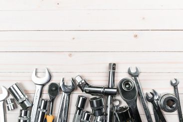 Collection of metallic tools arranged on a wooden...