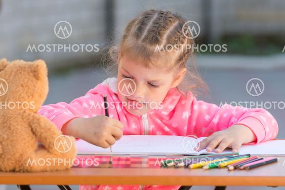 The girl stuck out her tongue enthusiastically drawing