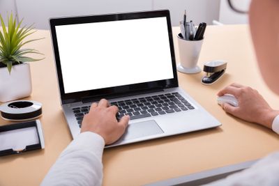 Businesswoman Using Laptop At Office Desk