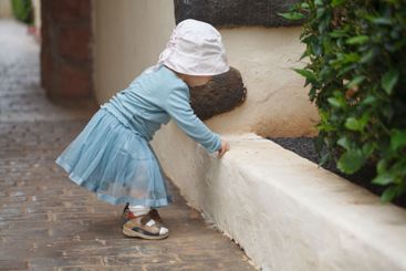 Playing little child girl outdoors. Childhood
