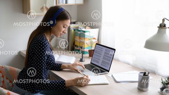 Focused young beautiful caucasian woman studying...