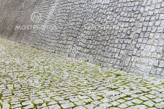 Cobblestone pavement and wall texture with moss