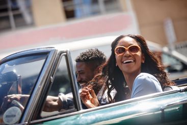 Black couple, car and road trip in city, freedom and...