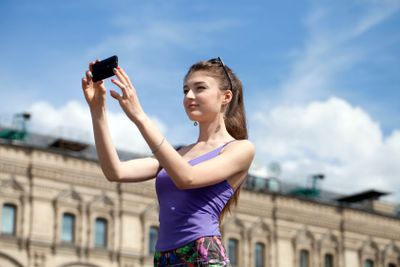 Young woman taking pictures on your phone