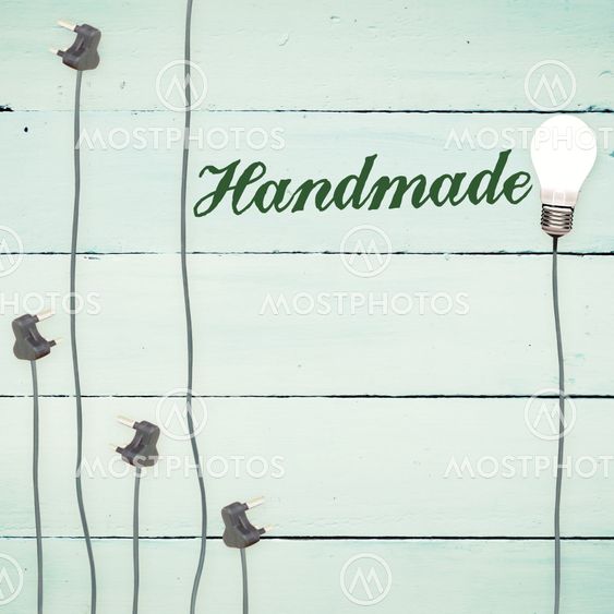 Handmade against light bulbs on wooden background