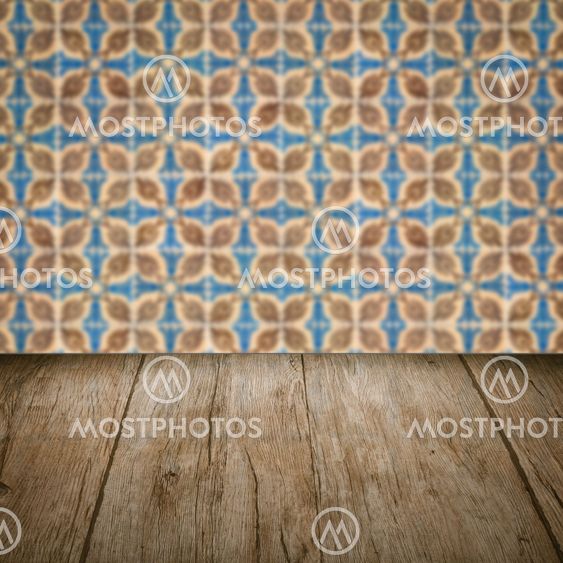 Wood table top and blur vintage ceramic tile pattern wall
