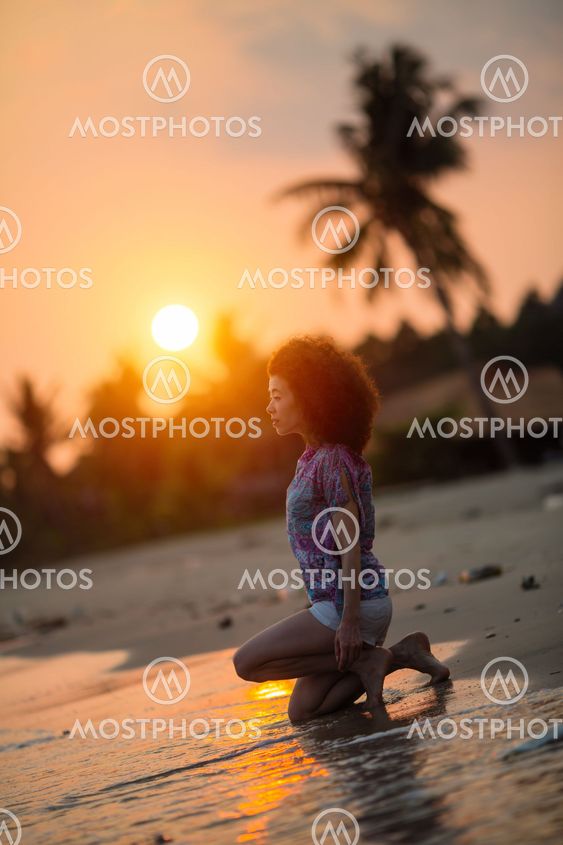 Young mixed race woman on a tropical beach during amazing...
