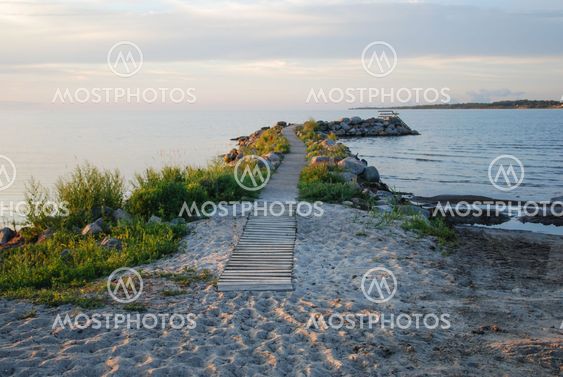 Winding bath pier by a sand beach