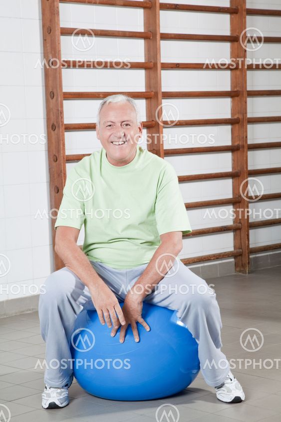 Senior Man Sits on a Fitball