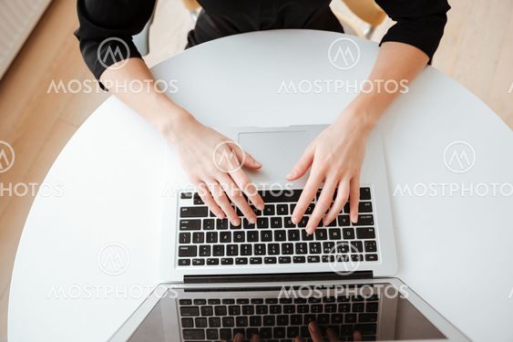 Top view photo of young lady using laptop computer