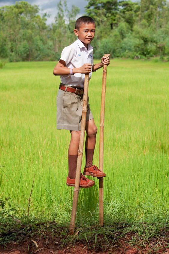 Boy goes on stilts