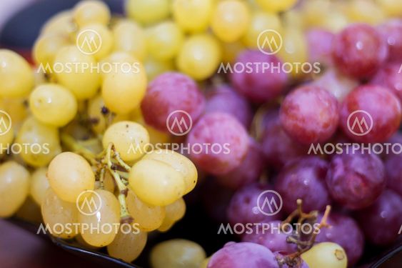 Red and White wine bunch of grapes in the black plate
