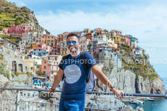 Young man enjoying the view of Manarola in the UNESCO...