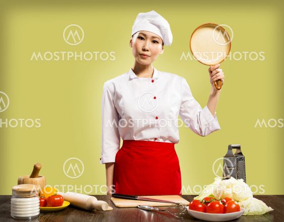 Chinese woman chef holding a ceramic pan