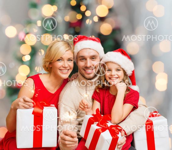 happy family in santa helper hats with gift boxes