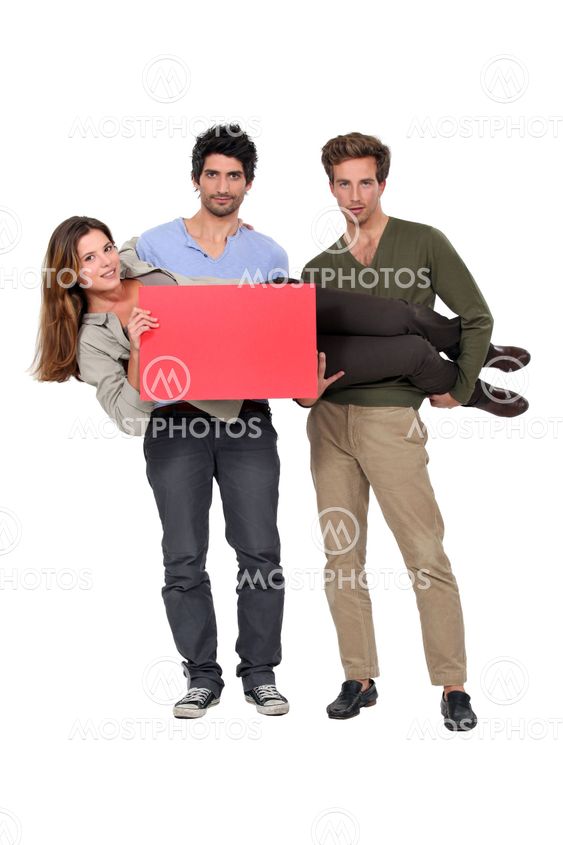 Two men carrying woman with poster