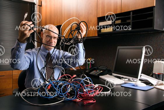 Businessman with computer cables.