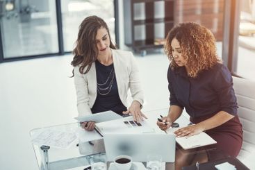 Meeting, paper and technology with business women in...