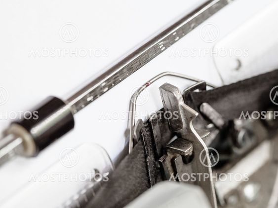 side view of typebar hits ink ribbon in typewriter