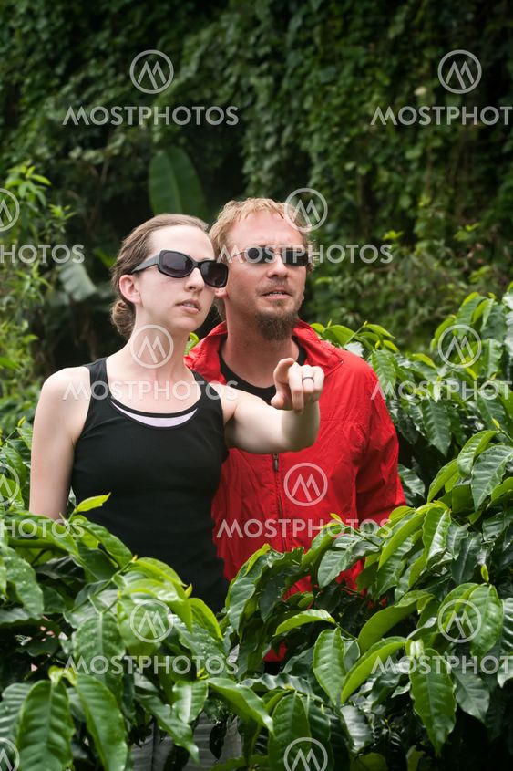 American and European couple on coffee plantation in...