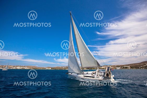 Sailing in the wind through the waves at the Sea. Luxury yacht at race.