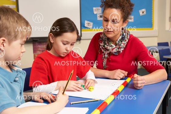 Schoolchildren Studying in classroom with teacher