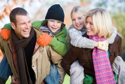Parents giving children piggyback ride