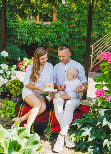 Mom and dad in nature with their one-year-old son...