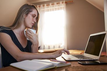 Young female working from home on laptop