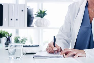 Doctor, hands or writing with script for medical...