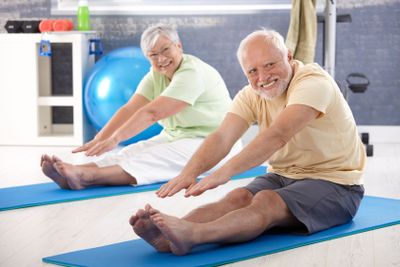 Elderly couple stretching�