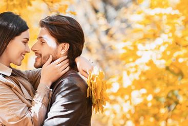 Loving girl touching her boyfriend face while cuddling...