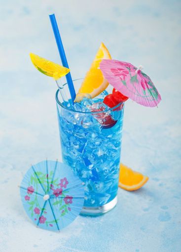 Blue lagoon summer cocktail in highball glass with sweet...