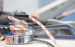 Winch with rope on sailing boat.