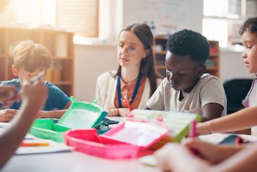 Writing, education and teacher helping students in...