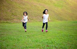 Asian Little Chinese Sisters running happily