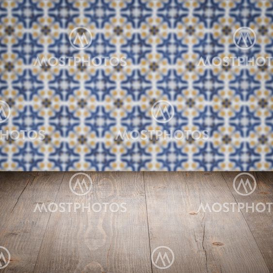 Wood table top and blur vintage ceramic tile pattern wall