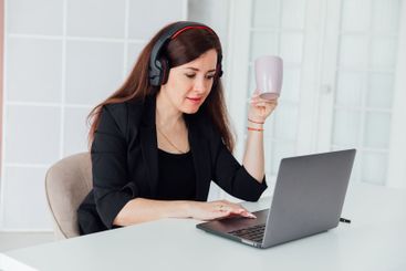 woman brunette sitting at table chatting online business