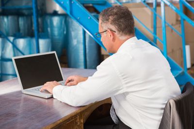 Warehouse manager working on computer