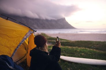 Seaside, camping and woman with picture, sunset and...