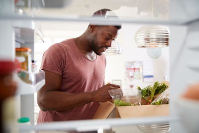 View Looking Out From Inside Of Refrigerator As Man...