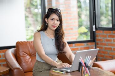 Portrait of Asian business female using laptop beautiful...