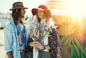 Travel, road trip and love with couple and flowers for...