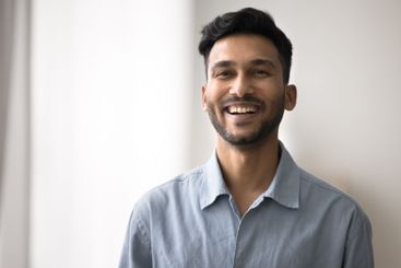 Head shot portrait handsome smiling young male looking...