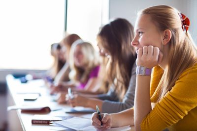 Students in a classroom during class (color toned image;...