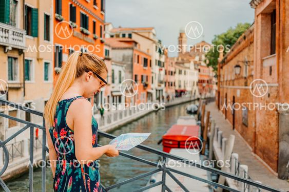 Young woman holding a map in Venice, Italy