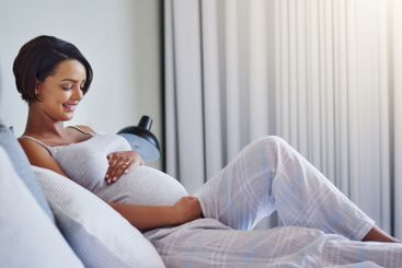 Woman, pregnant and hands on stomach for motherhood,...