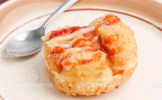 Bread stuffed with ham, topped with sauce.
