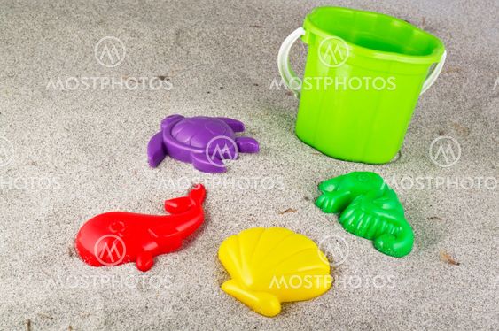 Child's bucket, spade and other toys on beach