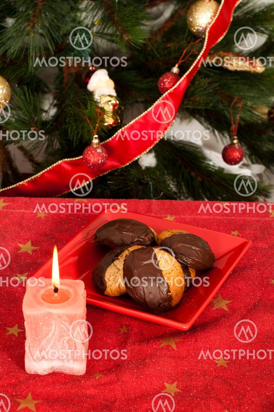 Christmas sweets and candle on the table